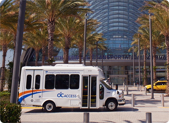 An OC Access vehicle parks in front of a station