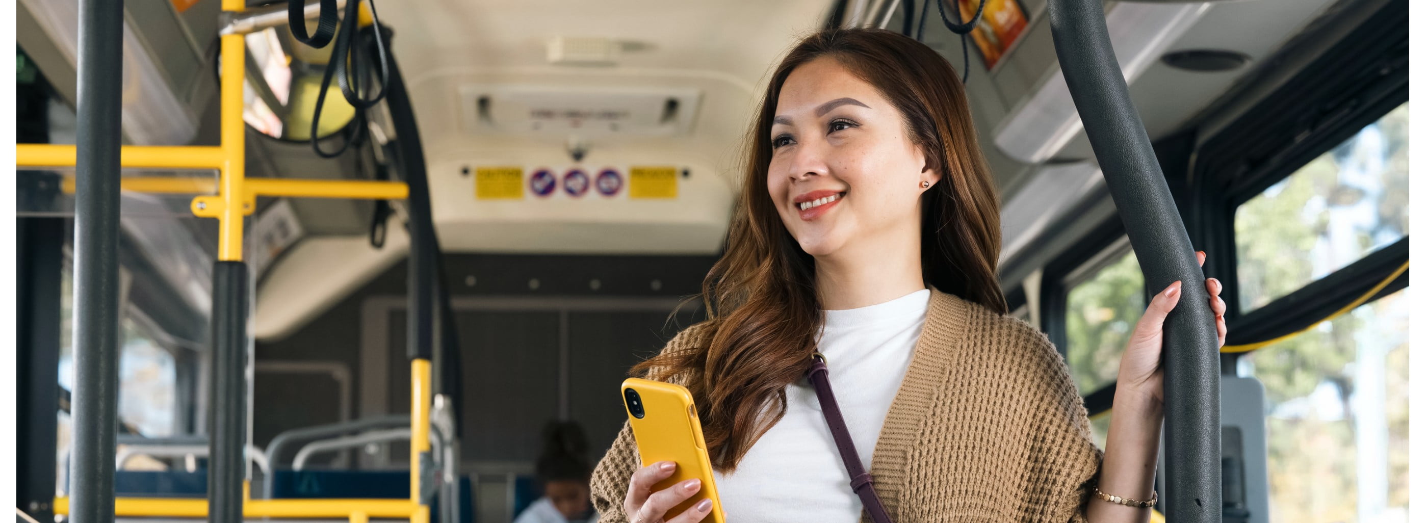 Woman on bus with mobile phone